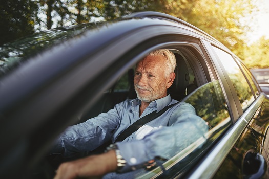 Senior man driving a car.